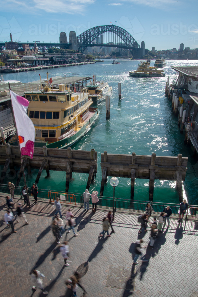 Busy crowds on Circular Quay, Sydney with the Harbour Bridge in the background - Australian Stock Image