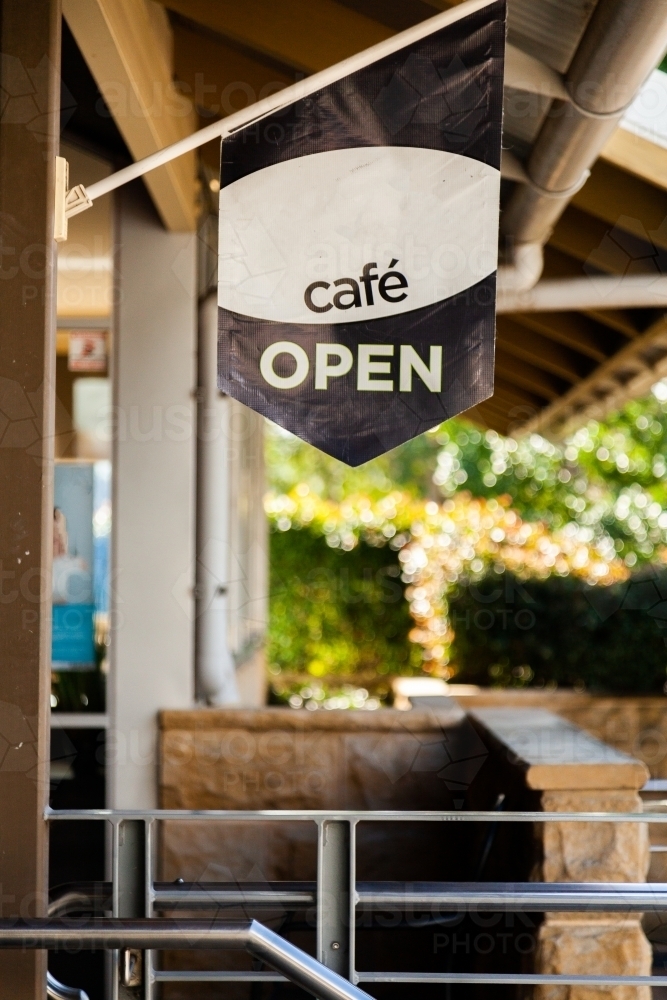 Cafe open sign flag hanging outside building - Australian Stock Image