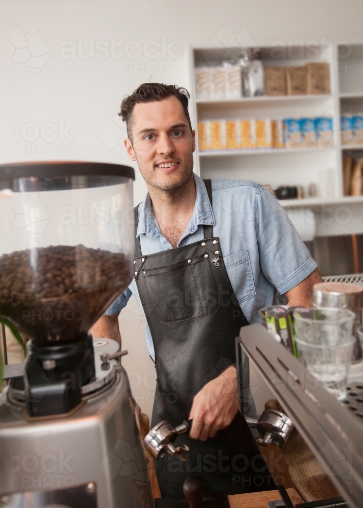 Cafe owner making coffee - Australian Stock Image