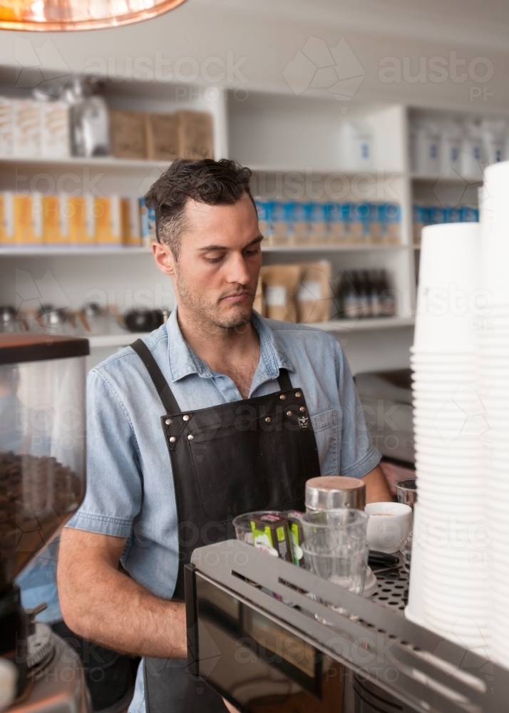 Cafe owner making coffee - Australian Stock Image