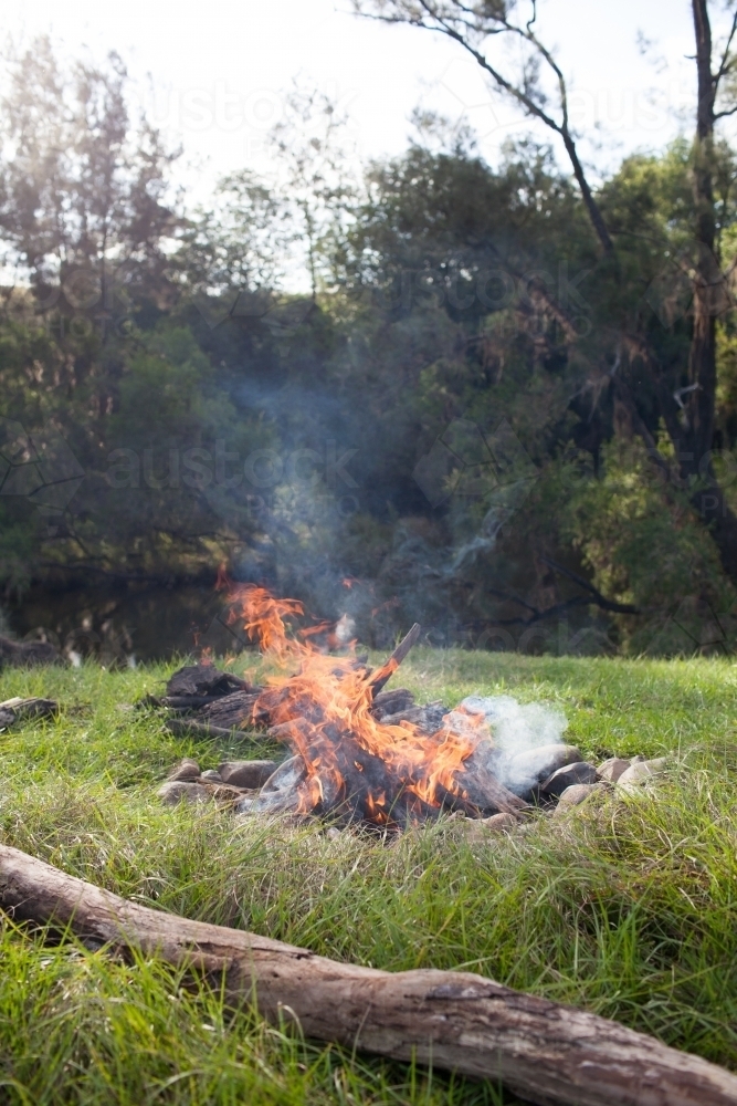 Campfire by a river - Australian Stock Image