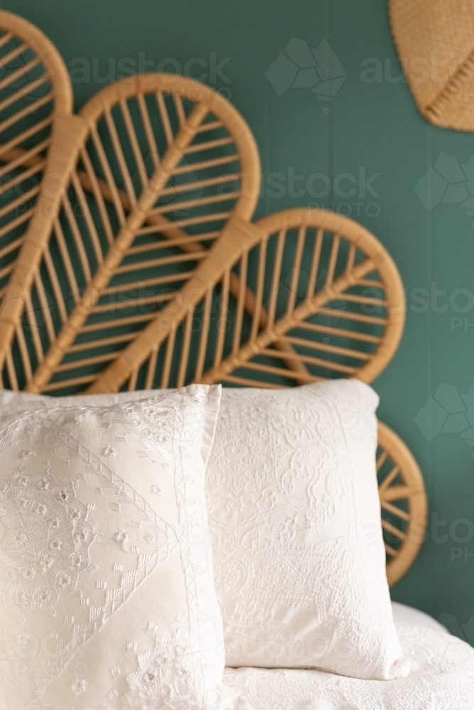 Cane bed head and pillows close up - Australian Stock Image