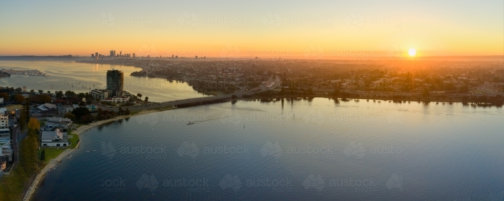 Canning Bridge and river in Perth, Australia as the sun rises on the horizon, with still water - Australian Stock Image