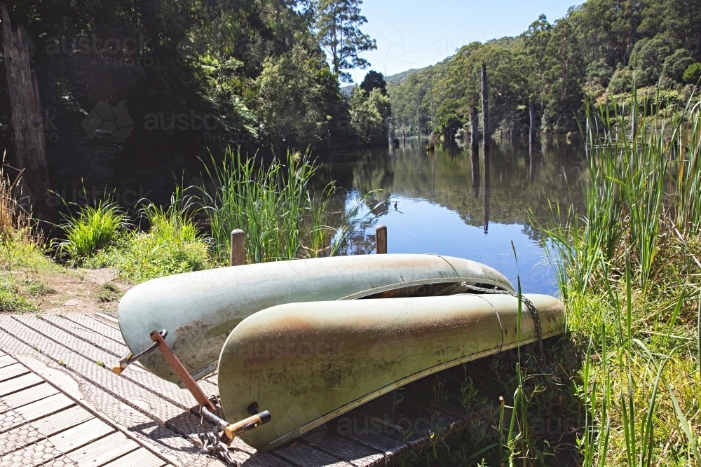 Canoes on edge of a lake - Australian Stock Image