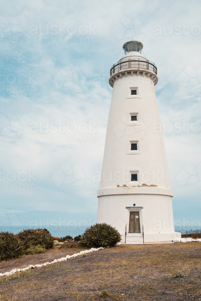 Cape Willoughby active lighthouse viewed against blue sky with clouds on a day, Kangaroo Island - Australian Stock Image
