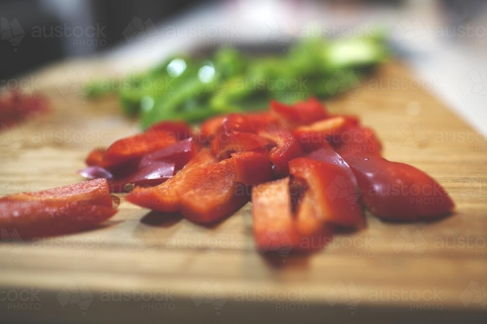 Capsicum on cutting board - Australian Stock Image