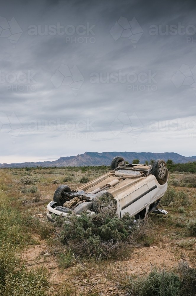 Car accident, a car rolled over after having an accident on a rural road - Australian Stock Image