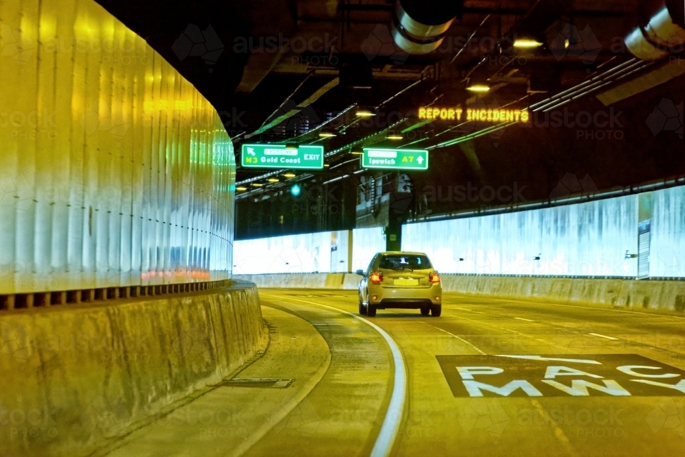 Car exiting an underground tunnel keeping a safe following distance - Australian Stock Image