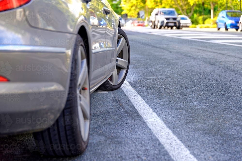 Car parked across solid white line parked on sealed road - Australian Stock Image