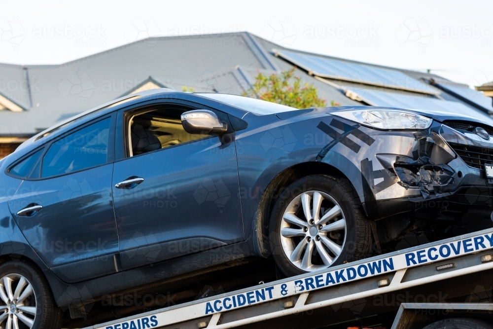 Car that was in accident being lifted onto town truck for accident and breakdown recovery - Australian Stock Image