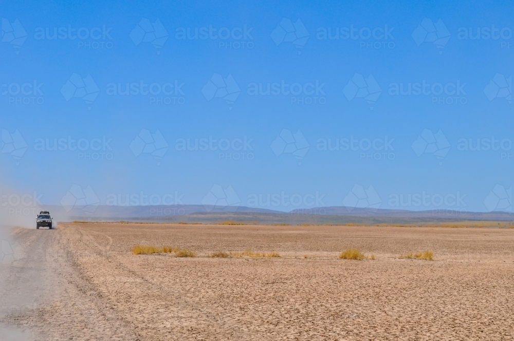 Car traveling on a dry gravel road - Australian Stock Image