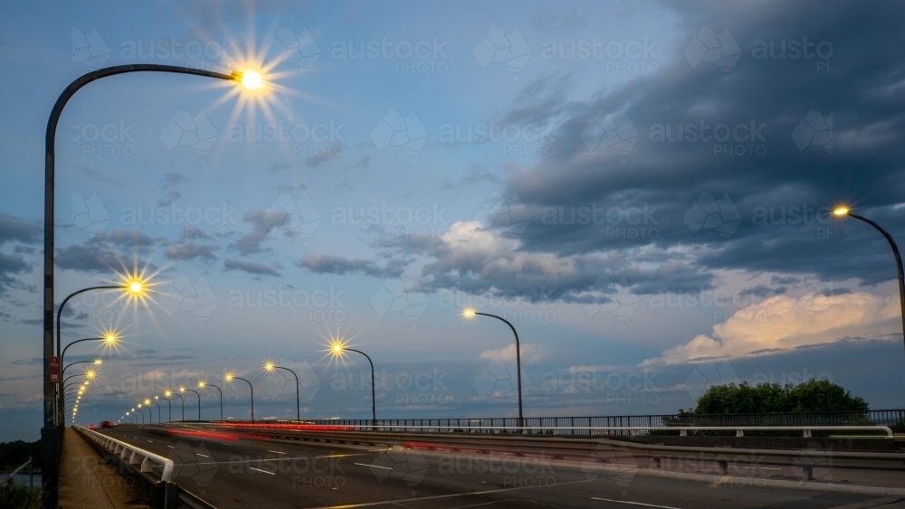 Cars going over bridge at dusk - Australian Stock Image