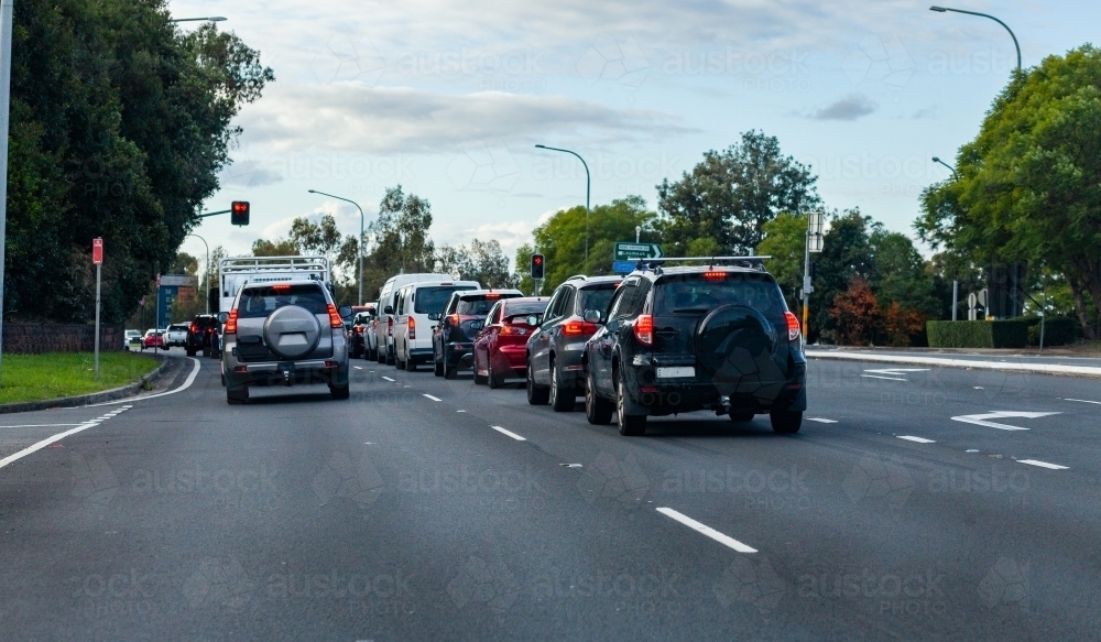 Cars in a queue at red traffic lights in Sydney on commute - Australian Stock Image