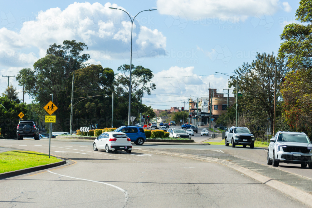 cars on roundabout in urban area - Australian Stock Image