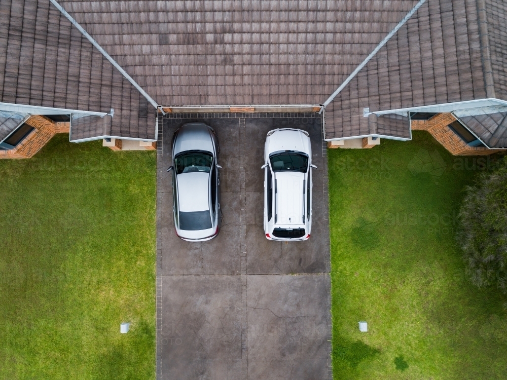 Cars parked in driveway of unit house - Australian Stock Image