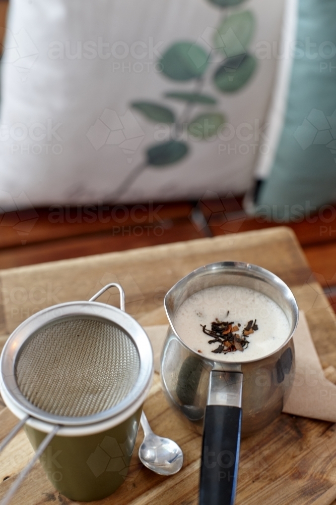 Chai latte prepared on table in cafe - Australian Stock Image