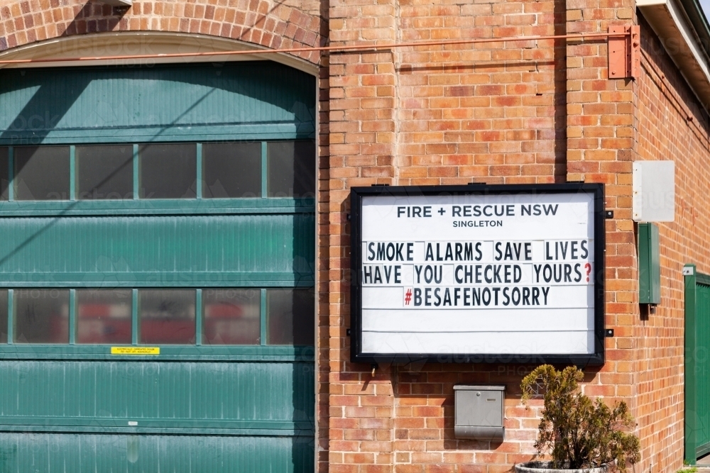 Check your smoke alarms stay safe warning sign on wall of fire brigade building - Australian Stock Image