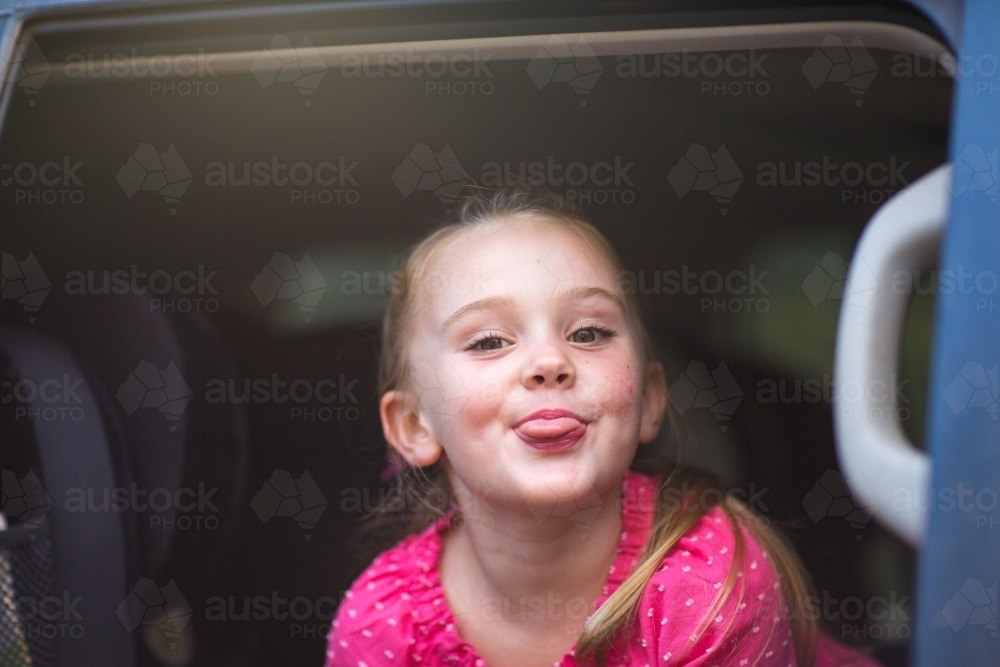 Cheeky kid poking tongue out - Australian Stock Image