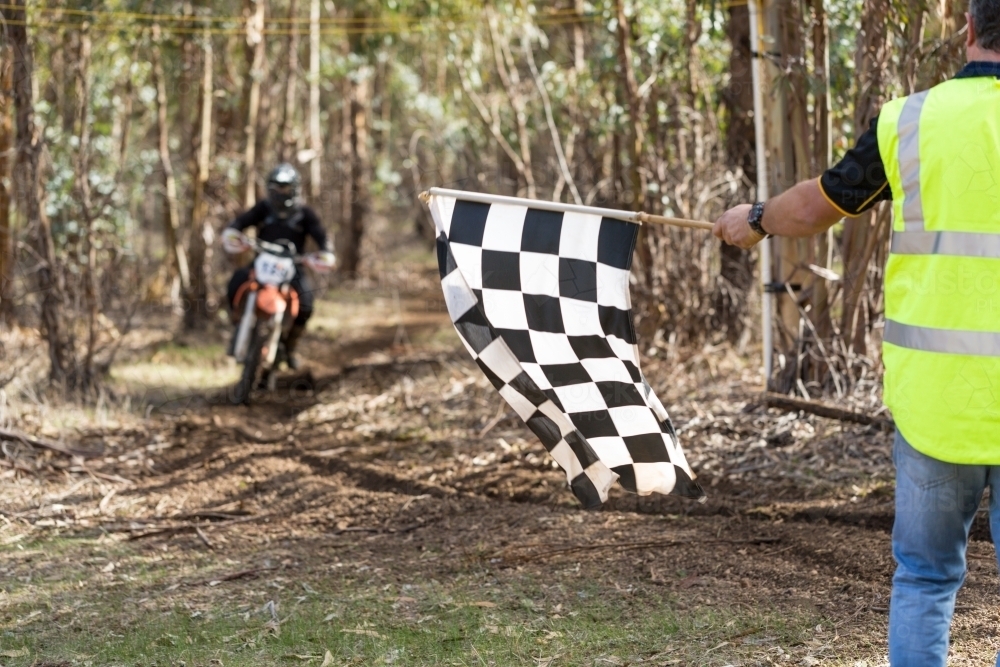 Chequered flag being waved at the end of a motorbike race - Australian Stock Image