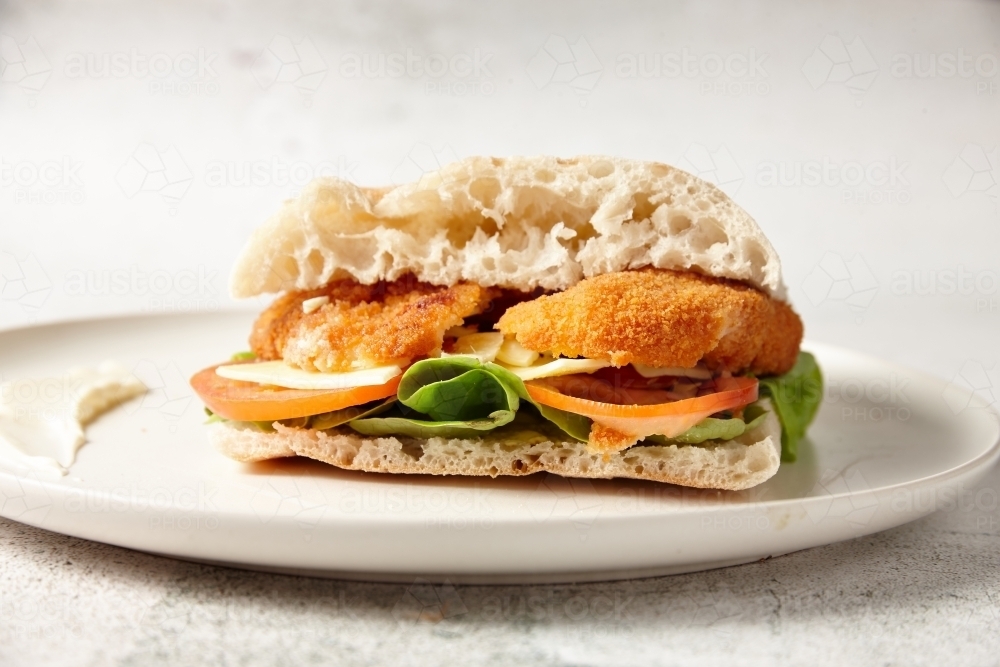 chicken schnitzel and turkish bread - Australian Stock Image