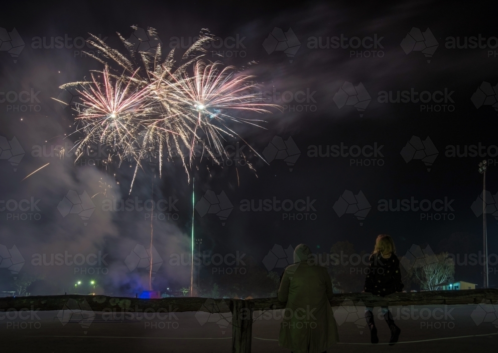 Child and adult watching firework display - Australian Stock Image