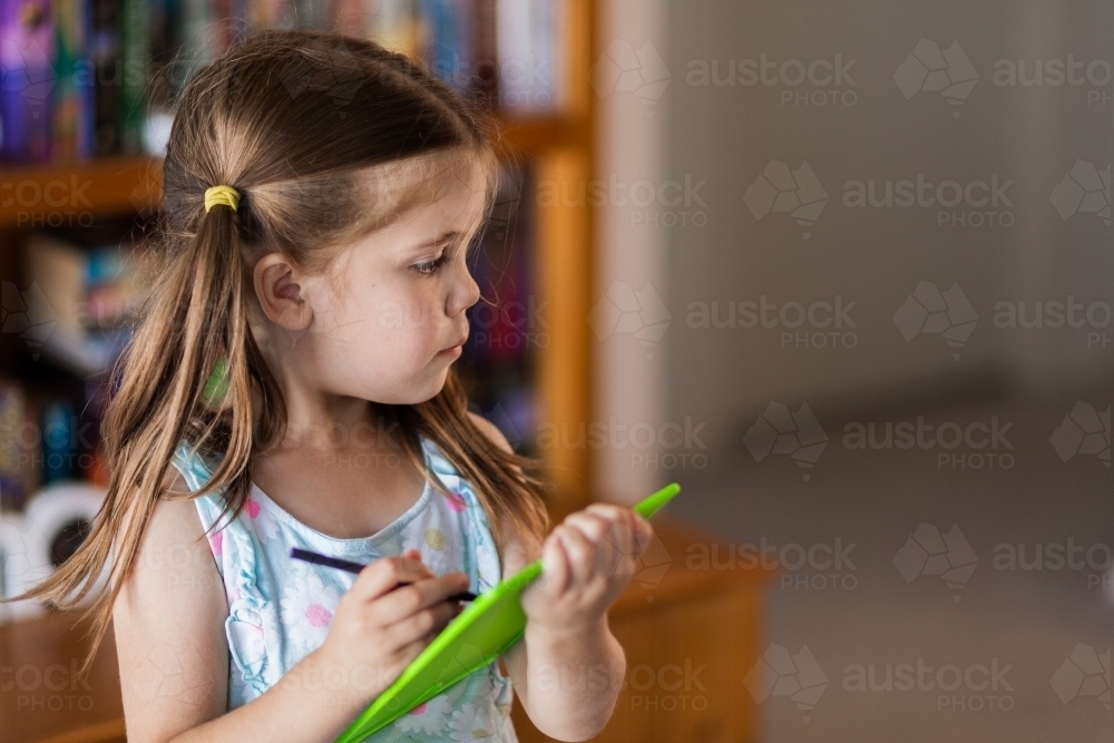 Image of Child drawing on digital art pad - Austockphoto