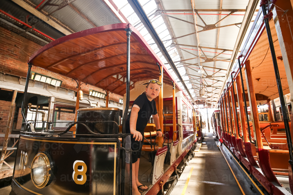 Child exploring vintage tram at historic museum - Australian Stock Image