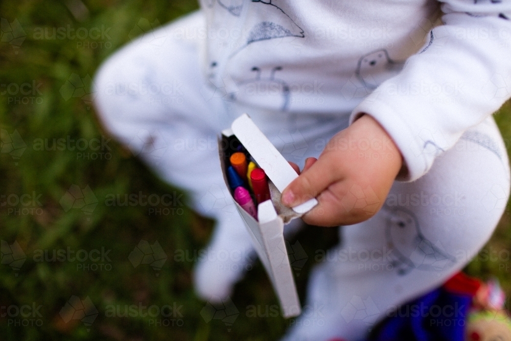 Child holding crayons - Australian Stock Image