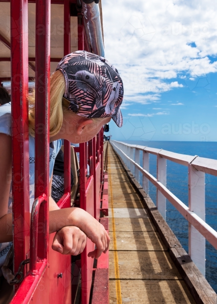 Child Looking Out to Sea Aboard Jetty Train - Australian Stock Image