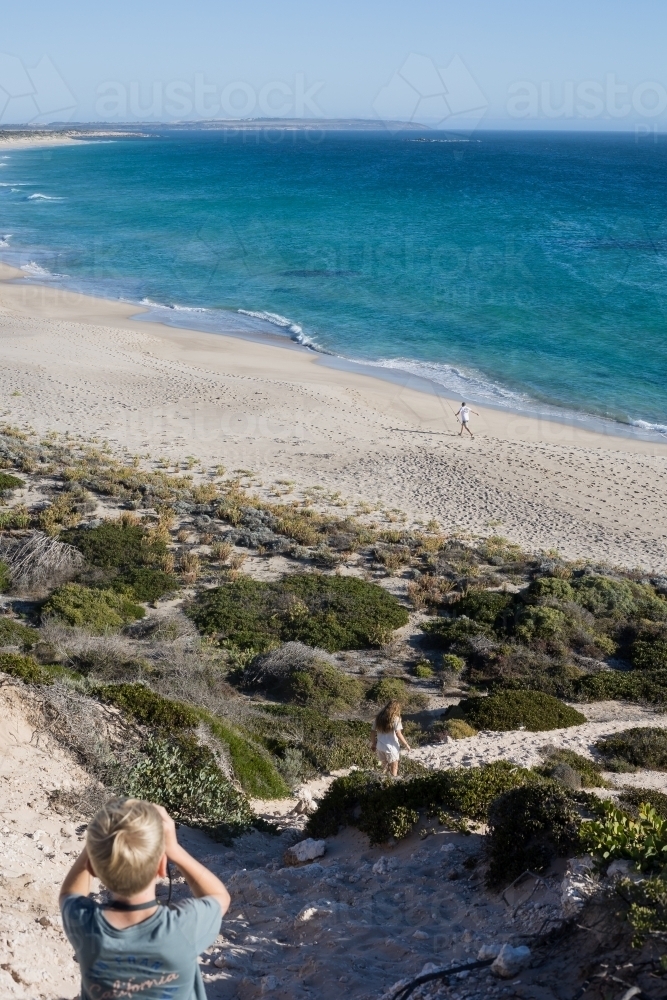 Child viewing remote beach seascape - Australian Stock Image