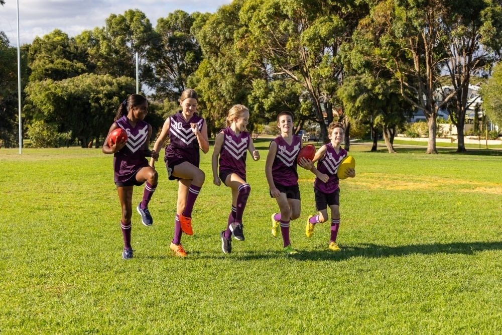 children in football team training on playing field - Australian Stock Image