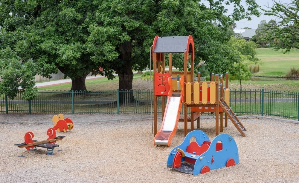 Children's playground with slide in the park - Australian Stock Image