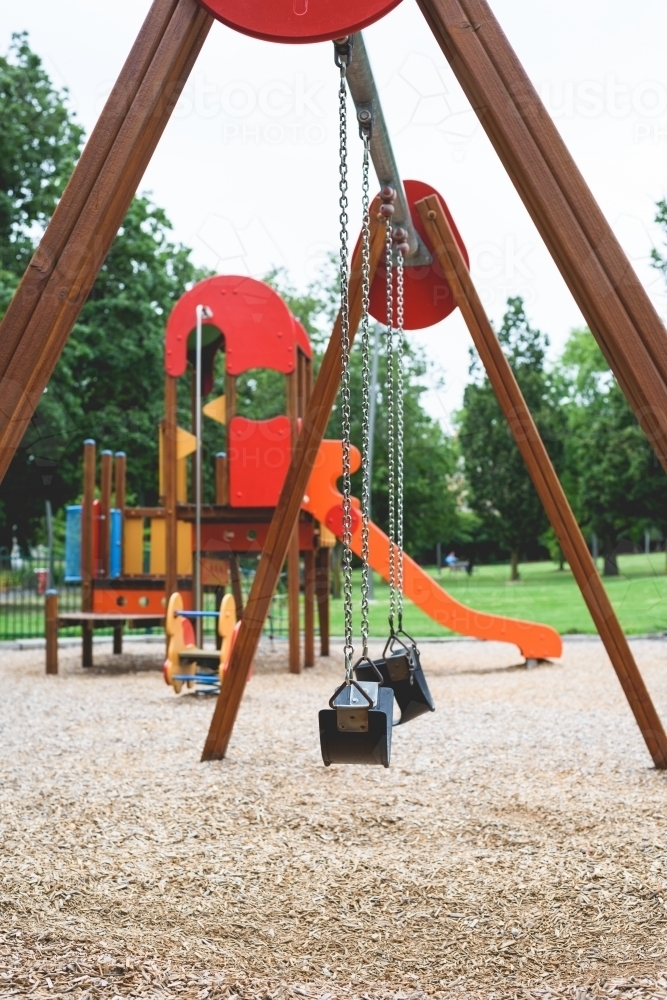 Children's playground with swing in the park - Australian Stock Image