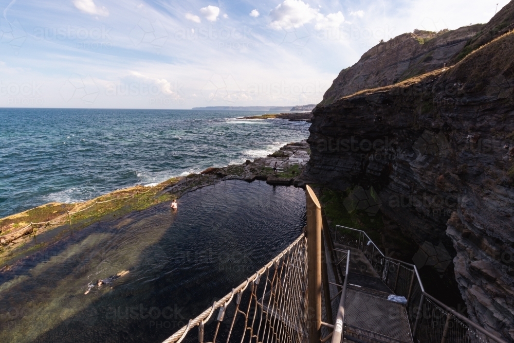 Children swimming in the Bogey Hole, historic man-made rock pool in Newcastle NSW - Australian Stock Image