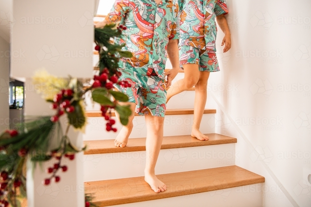 children walking barefoot down the stairs - Australian Stock Image