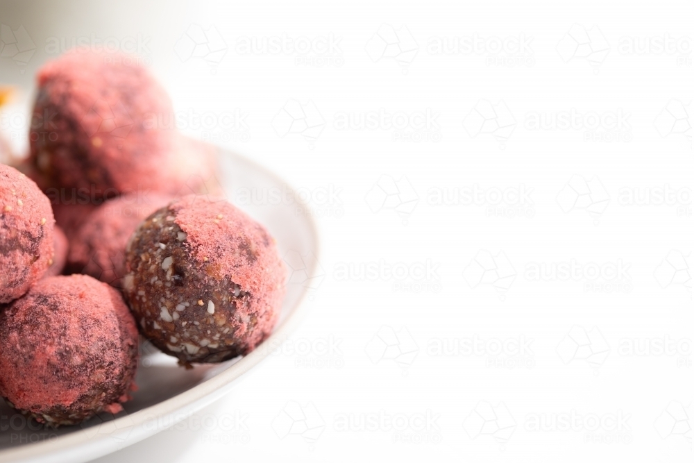 Chocolate protein balls on a white kitchen bench - Australian Stock Image