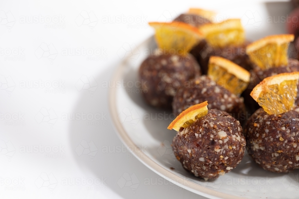 Chocolate protein balls on a white kitchen bench - Australian Stock Image