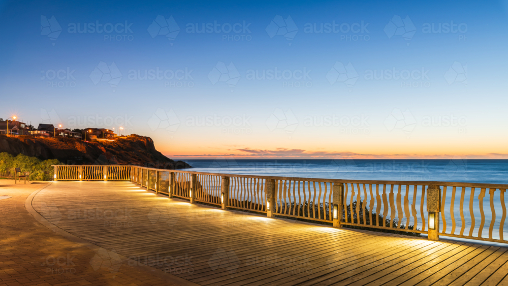 Christies Beach esplanade with Witton Bluff trail illuminated at night time - Australian Stock Image