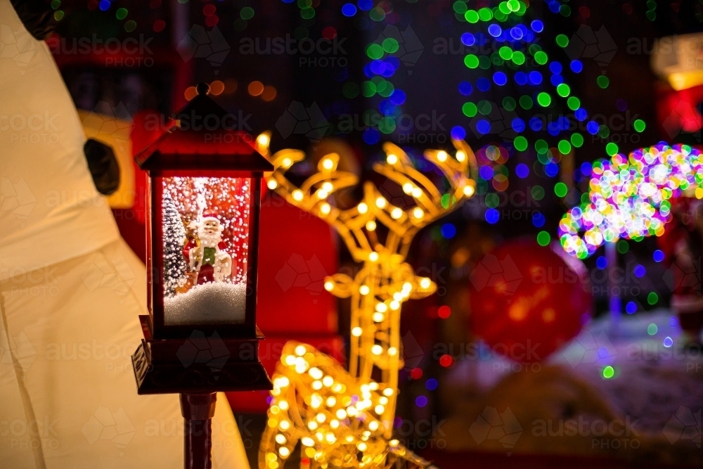 christmas light display with snow globe santa and light up reindeer - Australian Stock Image