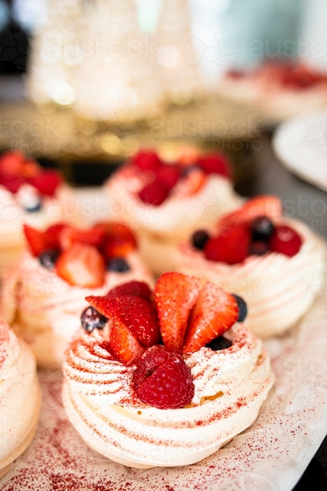 Christmas meringues with raspberry, strawberry, blueberry and cream - Australian Stock Image