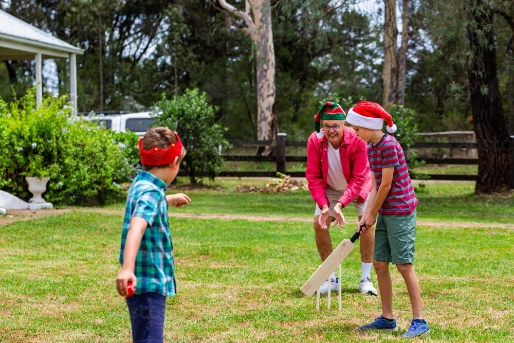 Image of Christmastime backyard cricket game two young aussie boys ...