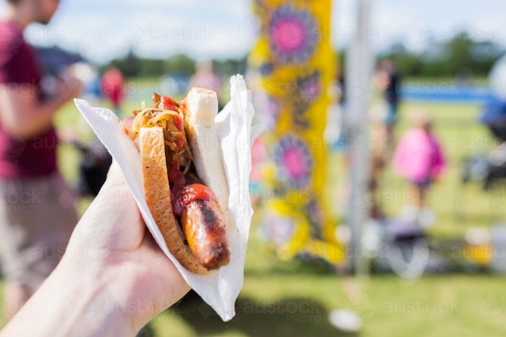 Classic summer event food of sausage in white bread and serviette - Australian Stock Image