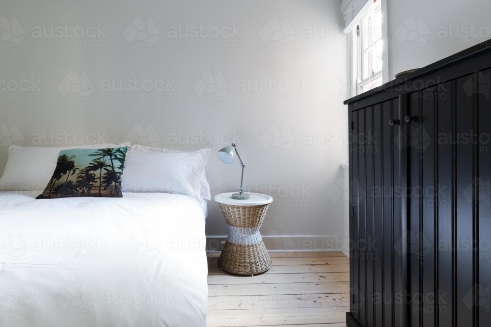 Clean white guest bedroom in modern designer apartment - Australian Stock Image