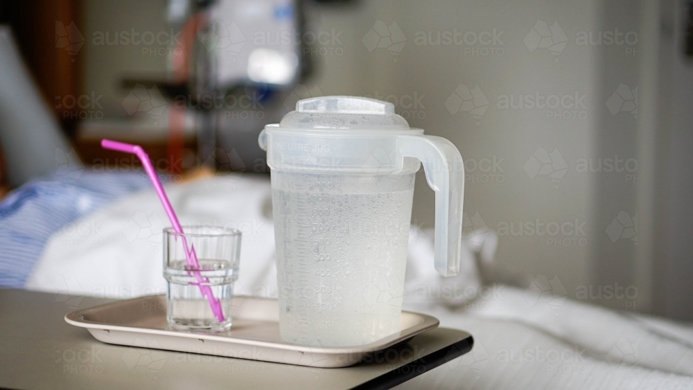 Close of hospital tray with water jug and glass - Australian Stock Image