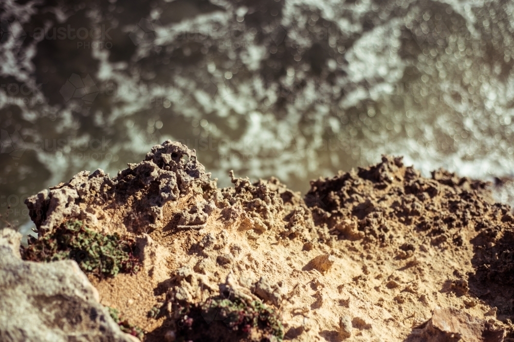 Close up looking down on rocks against water - Australian Stock Image