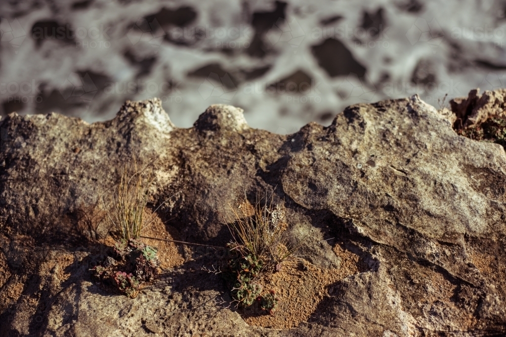 Close up looking down on rocks against water - Australian Stock Image