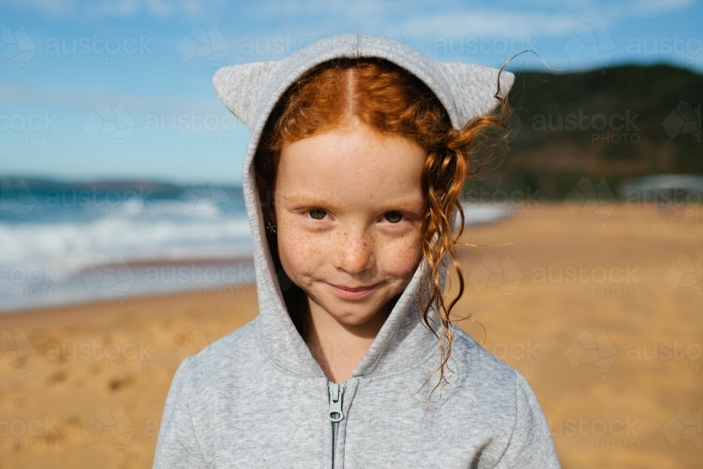 Close up of a young girl in a grey hoodie with ears - Australian Stock Image