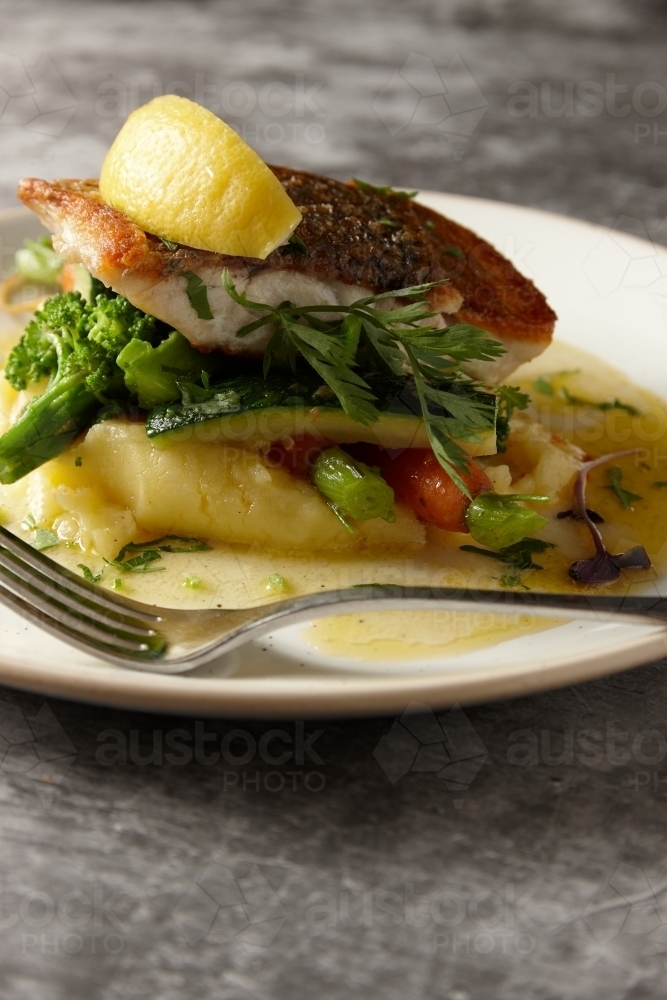 Close up of delicious barramundi dish on plate - Australian Stock Image