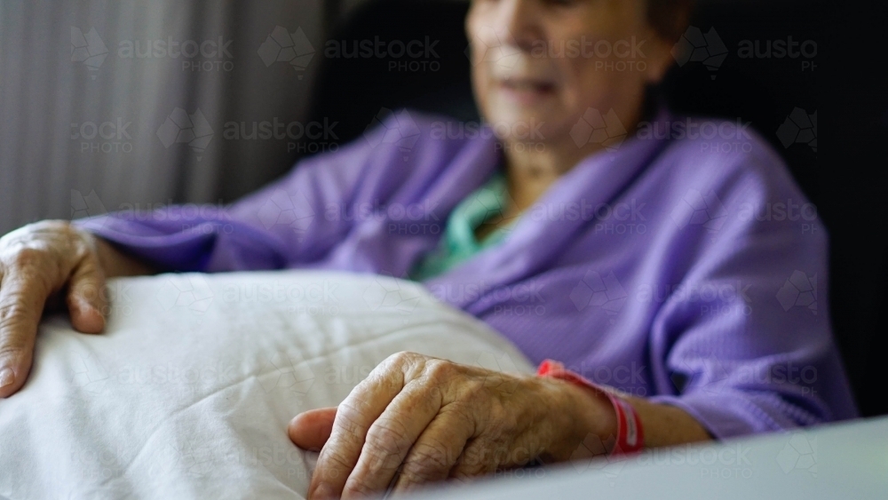 Close up of female patients hand with name tag - Australian Stock Image