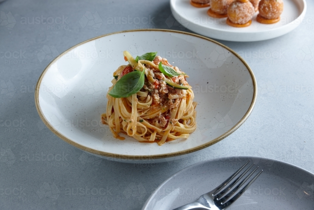 Close up of fresh pasta dish on table - Australian Stock Image